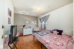 Room featuring wood-finish flooring, a neutral paint palette, and a window with natural light - 