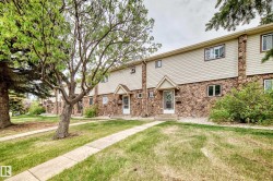 Townhome exterior featuring stone veneer and horizontal siding - 
