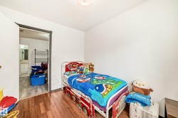 White painted walls with wood-finish flooring extending into the doorway - 