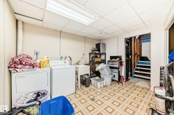 Dedicated laundry area featuring a utility sink, patterned flooring, and overhead fluorescent lighting - 