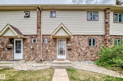 Stone facade townhouse with vinyl siding upper level - 
