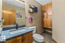 Bathroom vanity with a dark countertop and integrated white sink - 