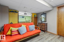 Finished lower level featuring wood-finish flooring, recessed lighting, and a neutral wall color palette - 