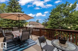 Expansive outdoor deck space featuring wood railings and a composite surface - 