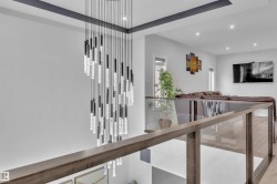 Dramatic multi-tiered chandelier illuminating a contemporary open-concept interior - 