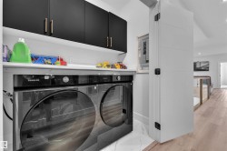 Dedicated laundry area featuring a front-loading washer and dryer set - 