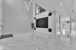 Spacious entryway featuring high ceilings and polished tile flooring - 