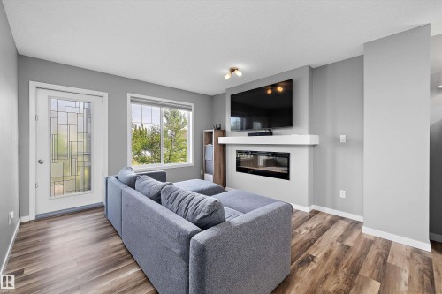 128 3305 Orchards Link, Edmonton, AB - Indoor Photo Showing Living Room With Fireplace