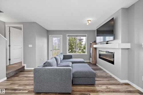 128 3305 Orchards Link, Edmonton, AB - Indoor Photo Showing Living Room With Fireplace