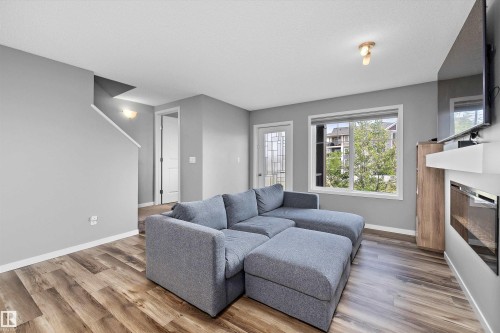 128 3305 Orchards Link, Edmonton, AB - Indoor Photo Showing Living Room With Fireplace