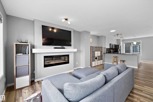 128 3305 Orchards Link, Edmonton, AB - Indoor Photo Showing Living Room With Fireplace