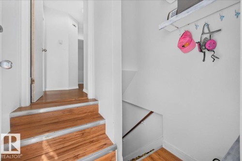 Staircase with wood-finish treads and metal nosing - 12134 42 Street Nw, Edmonton, AB - Indoor Photo Showing Other Room