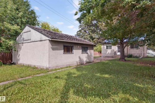 Detached garage featuring stucco siding and a shingle roof - 12134 42 Street Nw, Edmonton, AB - Outdoor