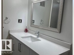 Modern vanity featuring an integrated rectangular sink, sleek chrome faucet, and bright white countertop - 