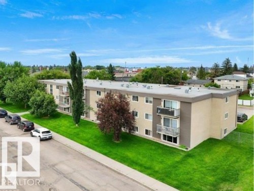 Three-story multi-unit residential building featuring a neutral-toned facade with contrasting accents - #103 10023 164St St Nw, Edmonton, AB - Outdoor