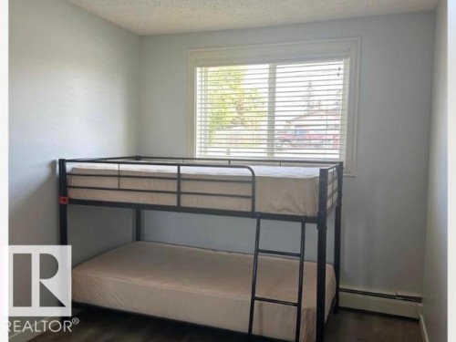 Room featuring light-colored walls and wood-finish flooring - #103 10023 164St St Nw, Edmonton, AB - Indoor
