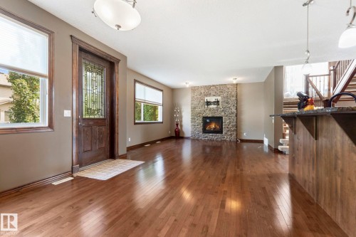 This photo shows the living room looking from the dining area - 25 Hilltop Ridge, Fort Saskatchewan, AB - Indoor Photo Showing Living Room With Fireplace