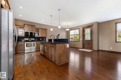 Open concept layout graced by hardwood flooring - 