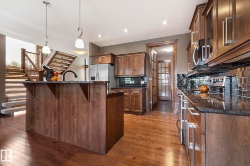 Loads of wood cabinetry - 25 Hilltop Ridge, Fort Saskatchewan, AB - Indoor Photo Showing Kitchen