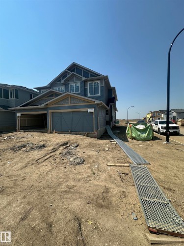 Two-story residence featuring light blue siding, decorative gable accents, and multiple windows - 704 22 Street Sw, Edmonton, AB - Outdoor