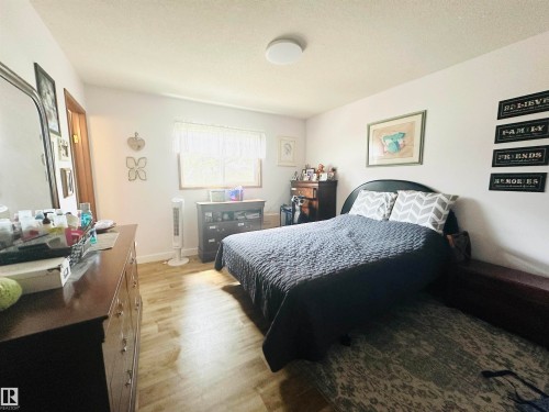 Bright room with wood-finish flooring and a window with white trim - 221 Parkview Drive, Wetaskiwin, AB - Indoor Photo Showing Bedroom