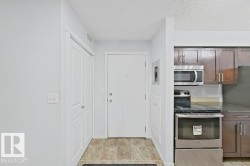 Entryway featuring tiled flooring, a white paneled closet, and a solid white entry door - 
