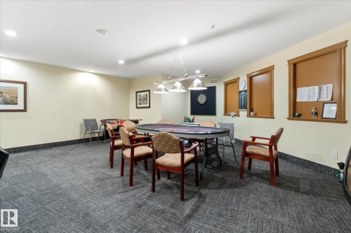 Recreation room featuring patterned carpet flooring and recessed lighting - #230 8802 Southfort Dr, Fort Saskatchewan, AB - Indoor