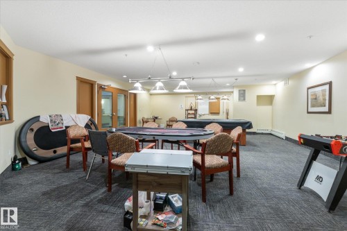 Expansive recreation room featuring durable carpet flooring, neutral wall tones, and recessed lighting - #230 8802 Southfort Dr, Fort Saskatchewan, AB - Indoor Photo Showing Dining Room