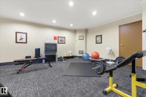 Carpeted room with recessed lighting and light-toned walls - #230 8802 Southfort Dr, Fort Saskatchewan, AB - Indoor