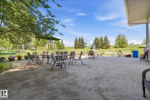 Expansive outdoor patio area featuring a concrete surface - #230 8802 Southfort Dr, Fort Saskatchewan, AB - Outdoor