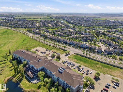 Multi-story building featuring multiple wings and an expansive parking area - #230 8802 Southfort Dr, Fort Saskatchewan, AB - Outdoor With View