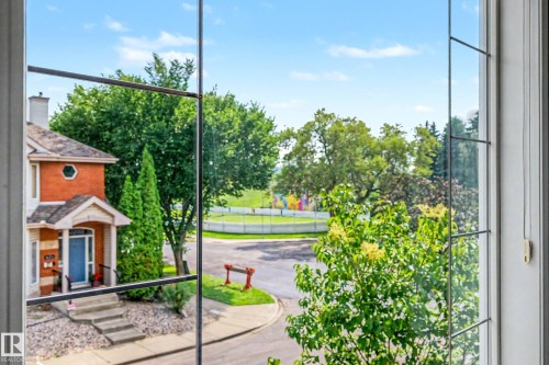 Window with grid panes overlooking a residential street - 9130 100A Avenue Nw, Edmonton, AB - 