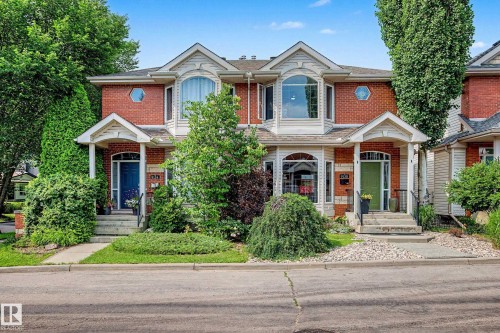 Brick facade townhome with gabled roofline and bay windows - 9130 100A Avenue Nw, Edmonton, AB - Outdoor With Facade