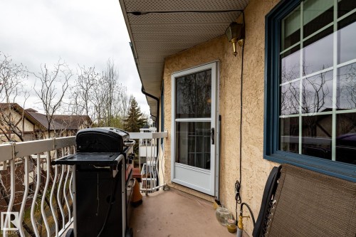 Private balcony with stucco exterior and white railings - #310 17151 94A Av Nw, Edmonton, AB - Outdoor With Exterior