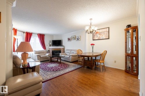 Open concept living and dining area featuring wood-finish flooring - #310 17151 94A Av Nw, Edmonton, AB - Indoor