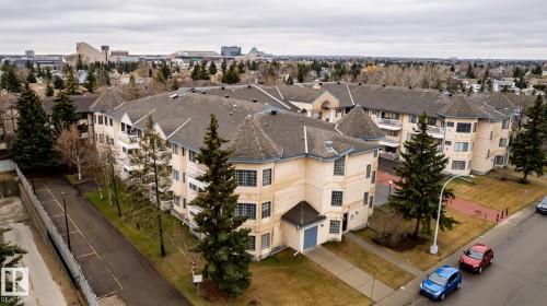 Multi-story residential building with light-colored exterior and dark-toned roofing - #310 17151 94A Av Nw, Edmonton, AB - Outdoor With View