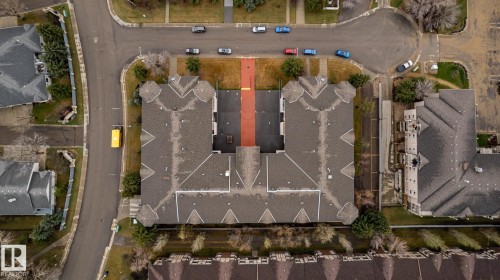 Aerial perspective showcasing a multi-unit property with complex rooflines and a central courtyard - #310 17151 94A Av Nw, Edmonton, AB - Other