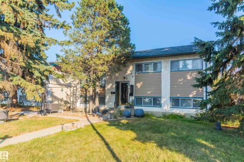 Exterior facade featuring a stucco finish with horizontal siding accents - 13208 128 Avenue Nw, Edmonton, AB - Outdoor