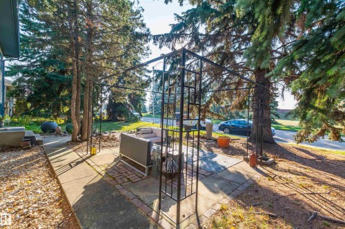 Outdoor patio area featuring a metal gazebo structure and a combination of concrete and brick paver flooring - 13208 128 Avenue Nw, Edmonton, AB - Outdoor