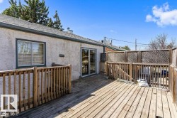 Spacious wood deck with perimeter railings and lattice privacy screens - 