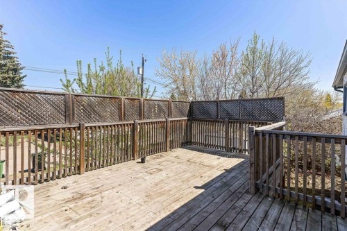 Spacious wood deck featuring a lattice privacy screen - 13208 128 Avenue Nw, Edmonton, AB - Outdoor With Deck Patio Veranda With Exterior