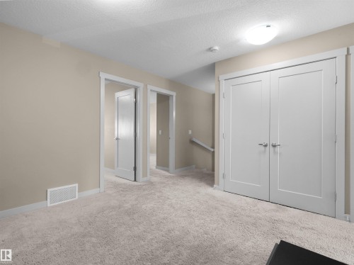 Plush light-toned carpeting spanning the floor - 4487 Annett Common Sw, Edmonton, AB - Indoor Photo Showing Other Room