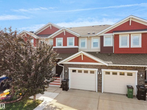 Townhome exterior featuring varied siding materials including red and tan shingles, and horizontal brown siding - 4487 Annett Common Sw, Edmonton, AB - Outdoor With Facade