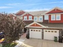 Townhome exterior featuring varied siding materials including red and tan shingles, and horizontal brown siding - 4487 Annett Common Sw, Edmonton, AB  - Outdoor With Facade 