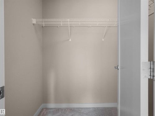 Closet space featuring neutral wall paint, white trim, and a white wire shelving system - 4487 Annett Common Sw, Edmonton, AB - Indoor With Storage