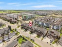 Aerial perspective showcasing a residential neighborhood with a mix of townhomes and detached houses - 4487 Annett Common Sw, Edmonton, AB  - Outdoor With View 