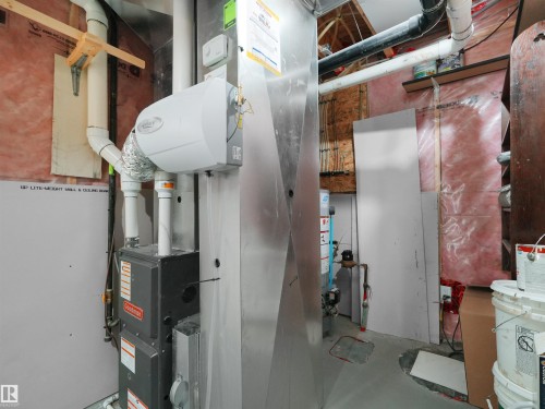 Utility area featuring a furnace system, a humidifier unit, and exposed ductwork - 4487 Annett Common Sw, Edmonton, AB - Indoor Photo Showing Basement
