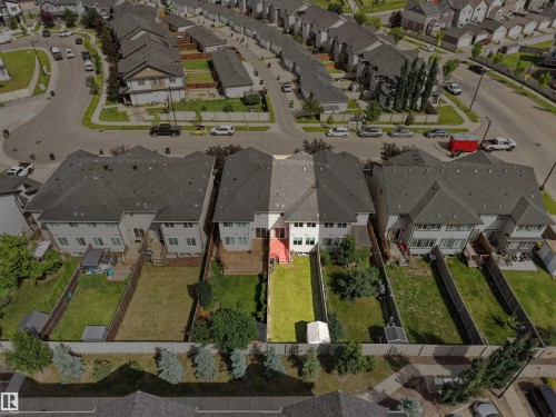 Backyard with fenced perimeter, green lawn, mature trees, and a small storage shed - 4487 Annett Common Sw, Edmonton, AB -  With View