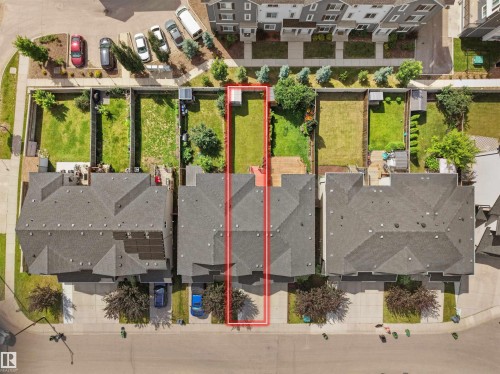 Residential property featuring a grey shingle roof, a paved driveway, and a private rear yard with green space - 4487 Annett Common Sw, Edmonton, AB - 