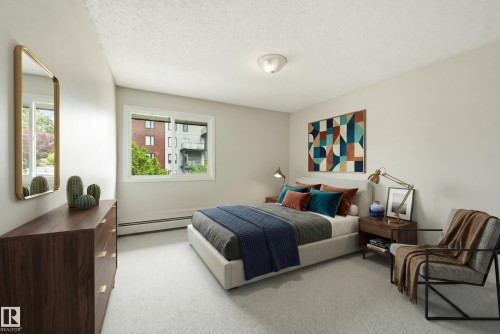 Neutral-toned interior featuring carpet flooring and white walls - #433 11217 103 Av Nw, Edmonton, AB - Indoor Photo Showing Bedroom